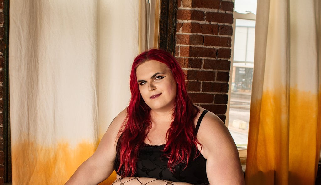 Audacia seated on a green velvet couch